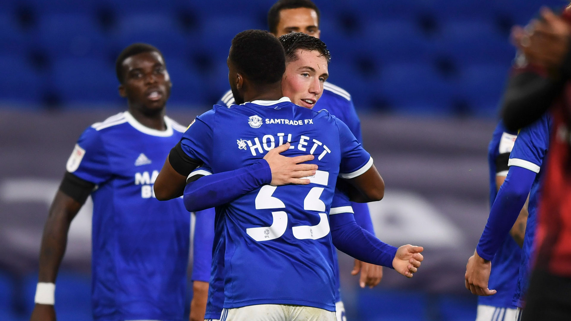 Harry Wilson celebrates his first City goal with Junior Hoilett...