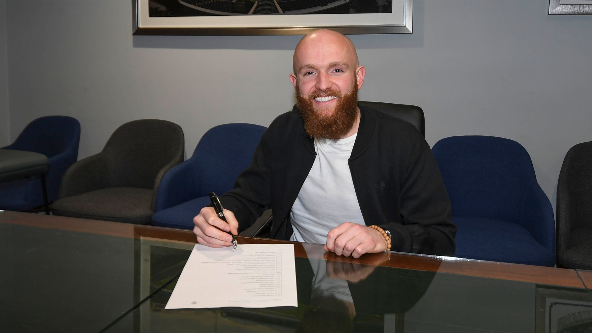 Jonny Williams signs his contract at CCS...