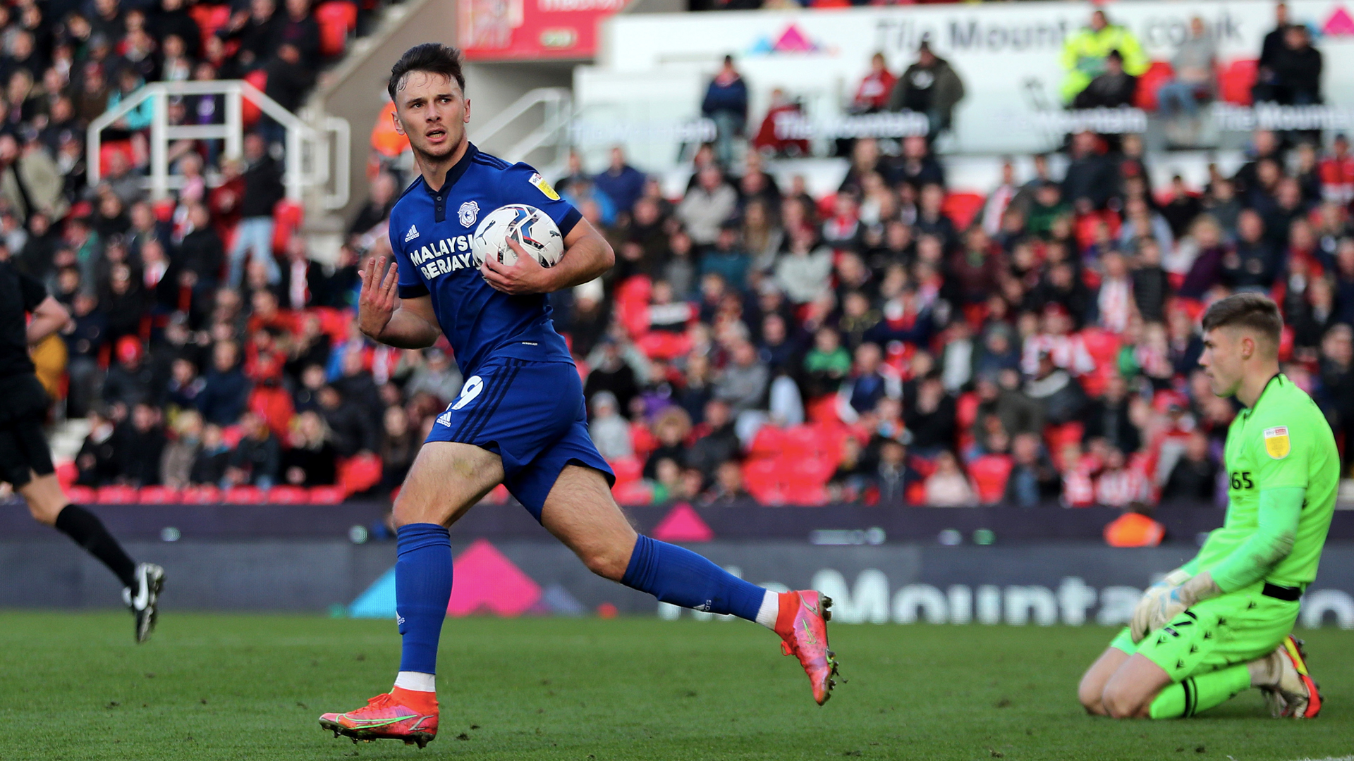 Mark Harris runs back to the halfway line with the ball...