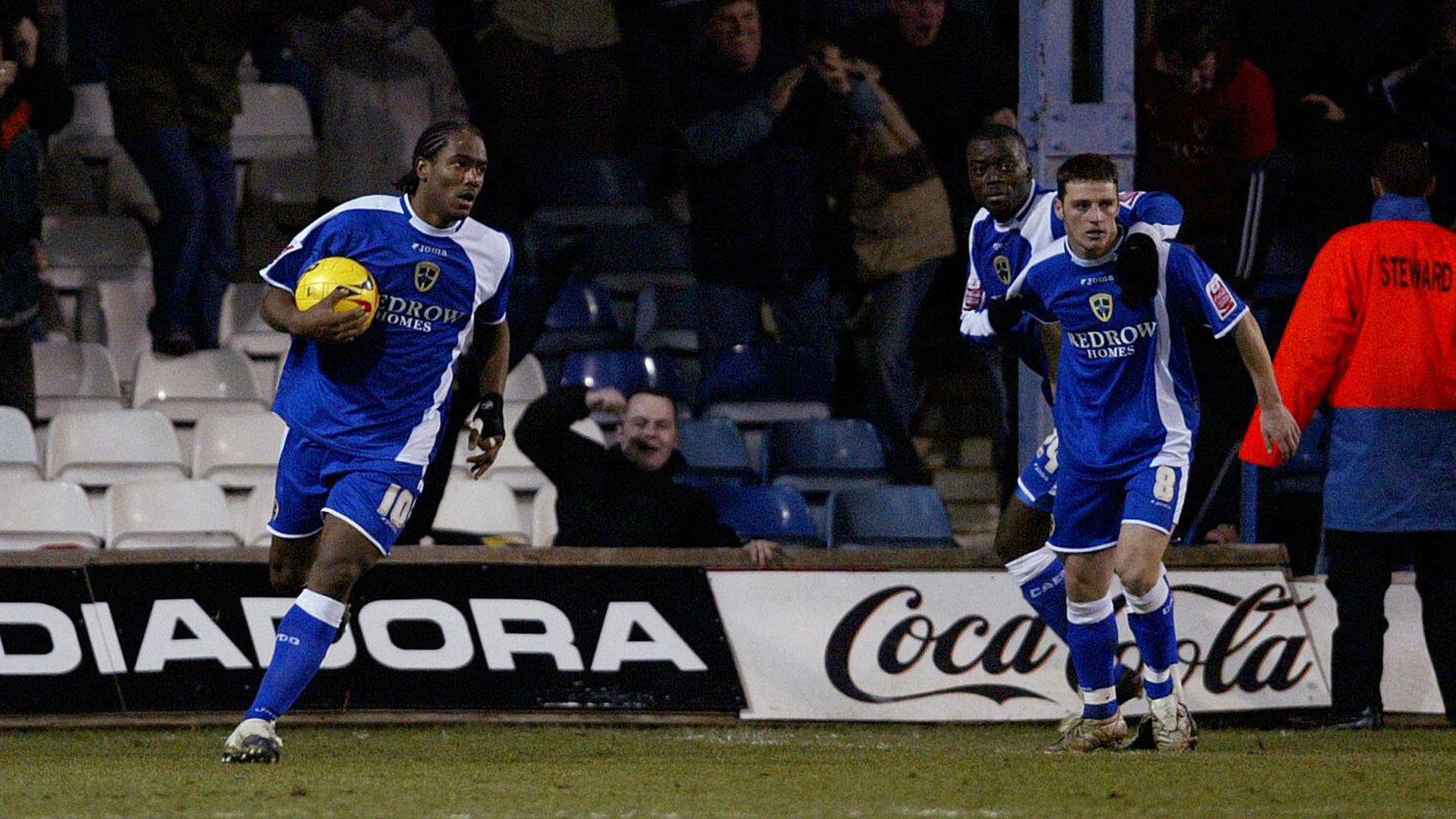 Koumas celebrates a goal at Kenilworth Road...