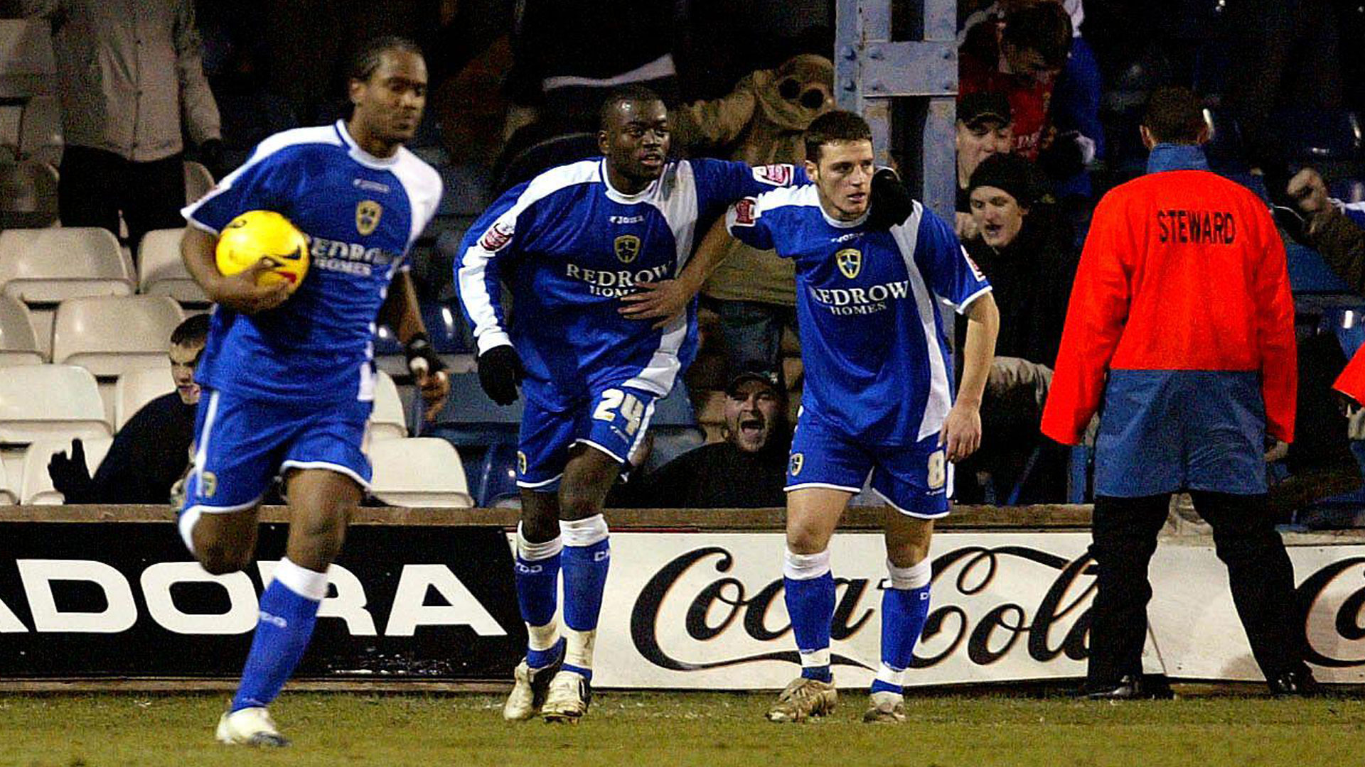 Koumas celebrates a goal at Kenilworth Road...