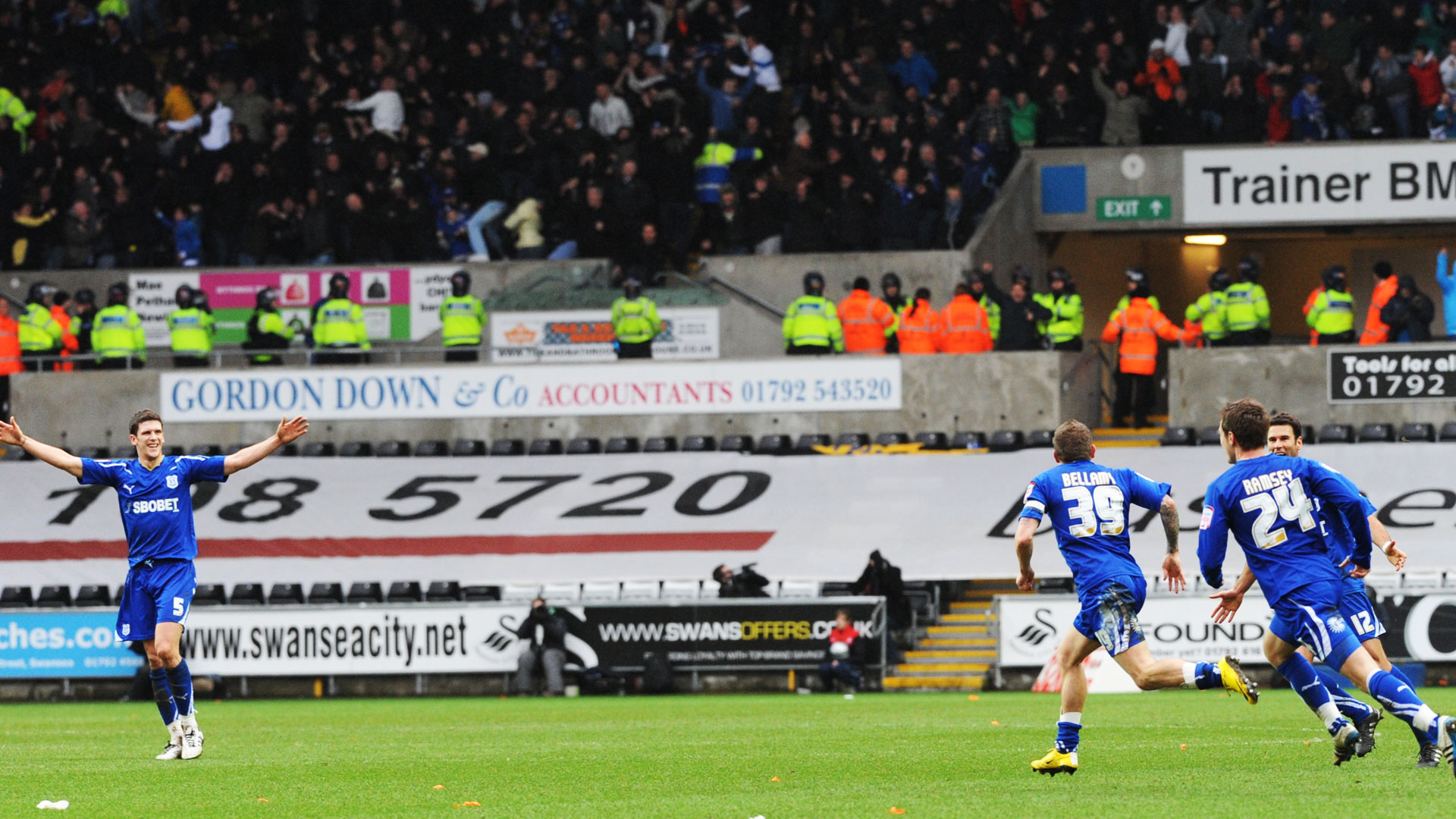 Mark Hudson, Craig Bellamy and Aaron Ramsey celebrate the winner...