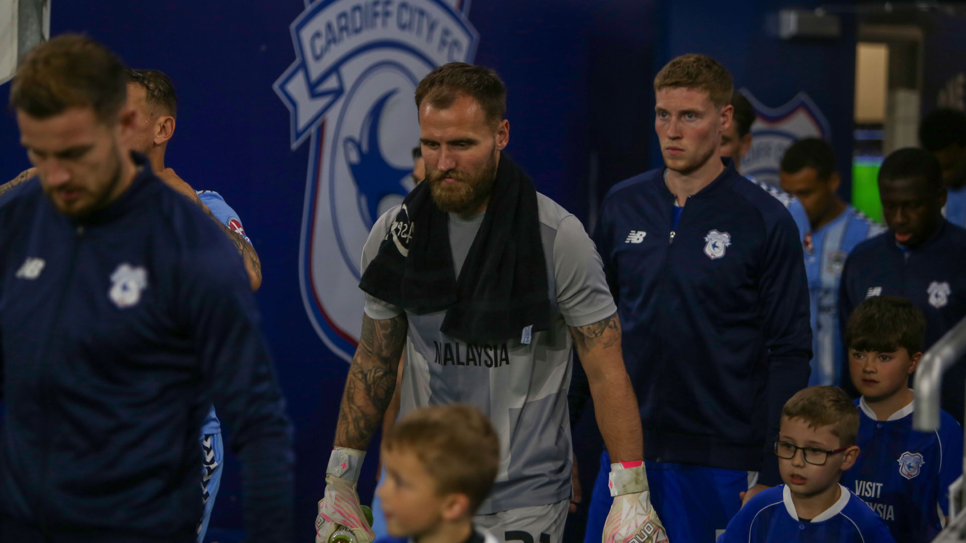 Jak Alnwick walks onto the field at Cardiff City Stadium