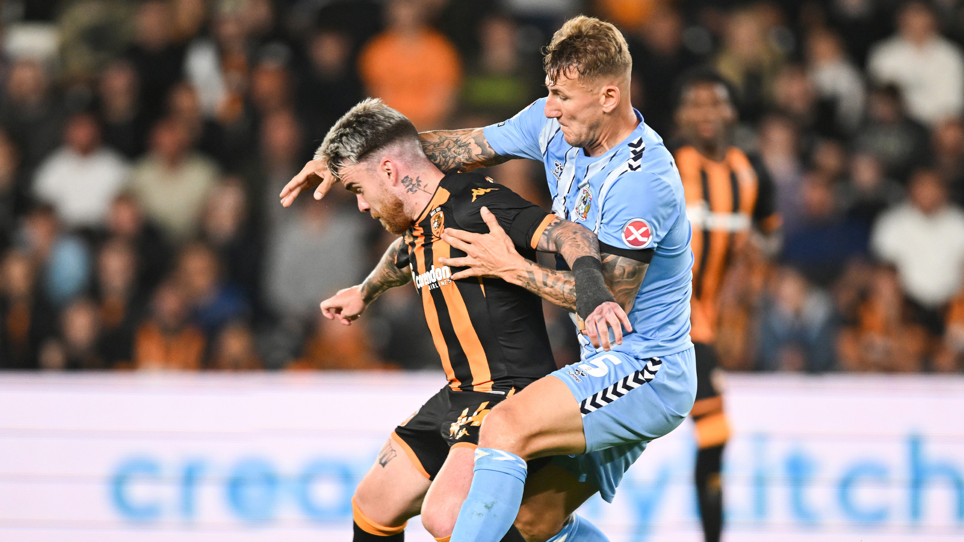 Kyle McFadzean of Coventry City challenges Aaron Connolly of Hull City
