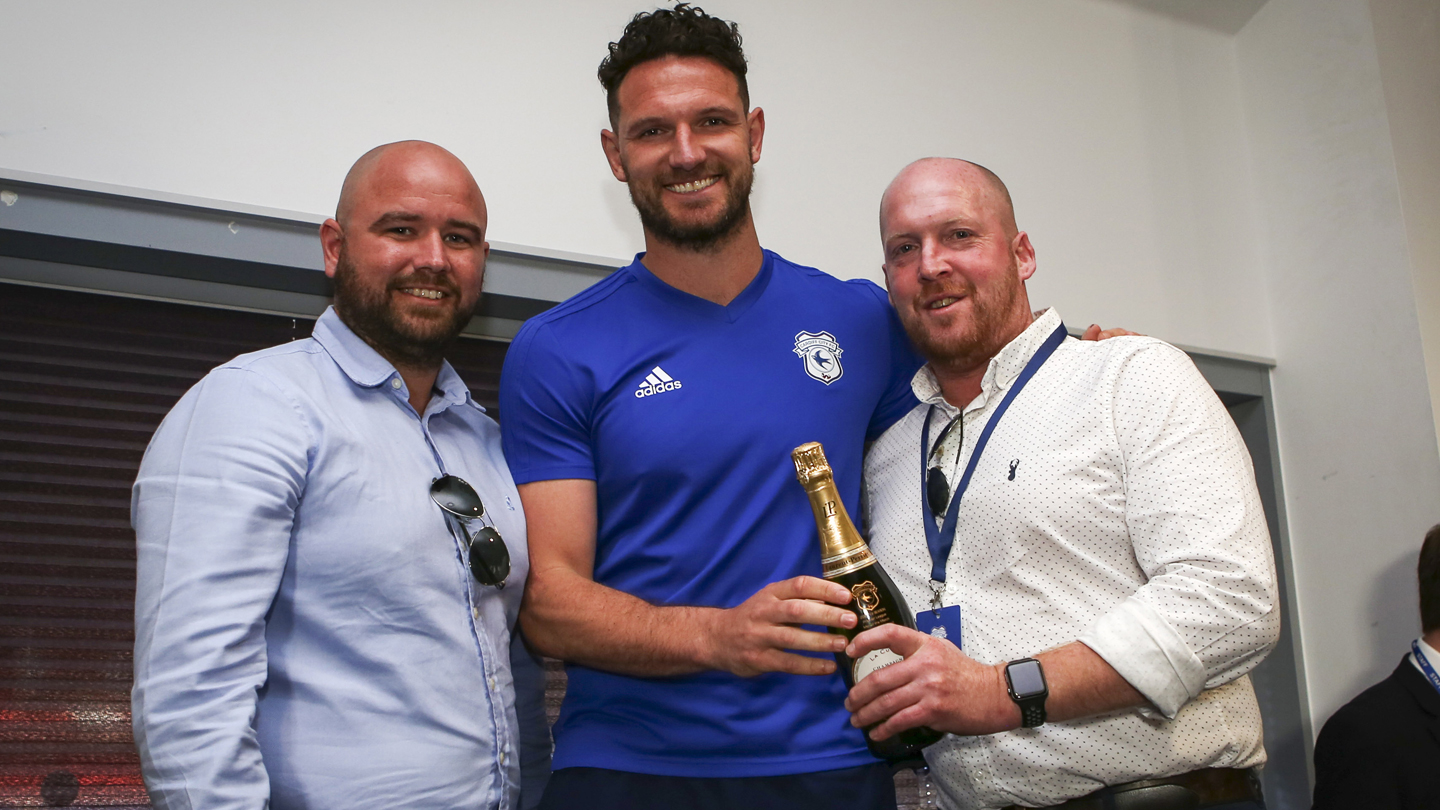 Sean Morrison presented with the Man of the Match champagne