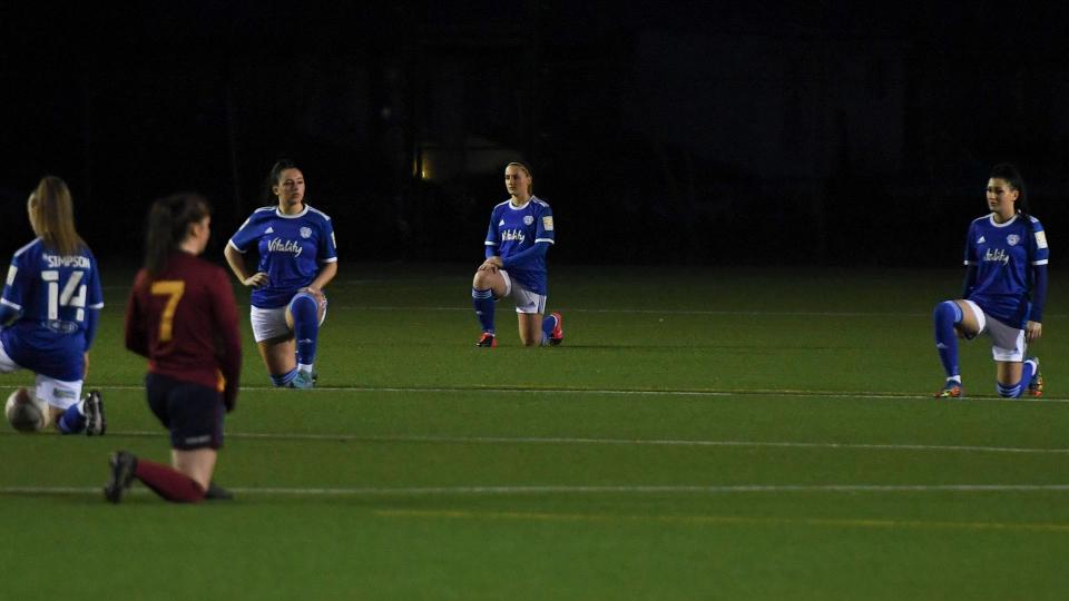 City & Met take the knee pre-match...