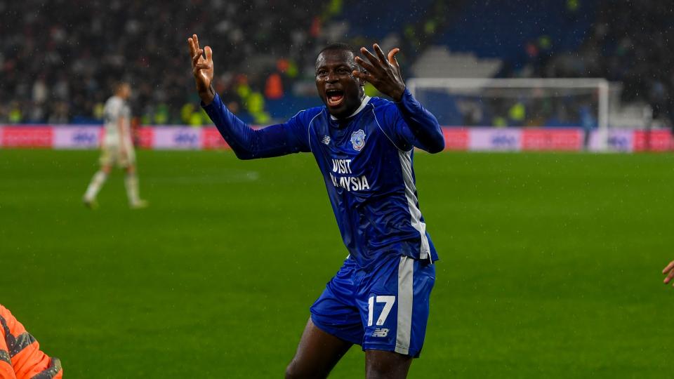 Jamilu Collions celebrates Ramsey's goal against Swansea City...