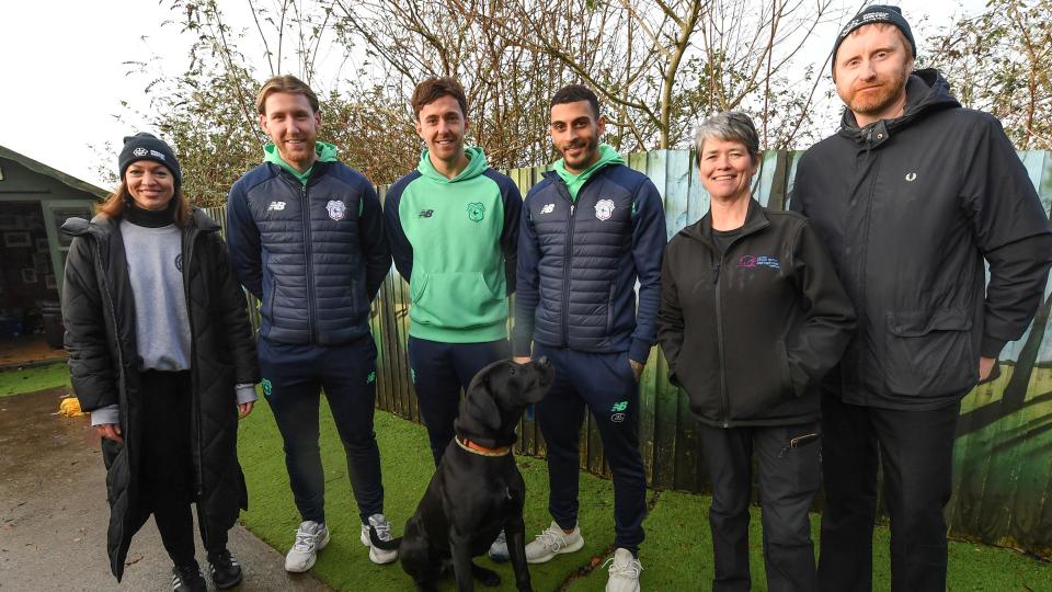 Ryan Wintle, Josh Bowler and Karlan Grant meet with representatives and pooches at Cardiff Dogs Home...