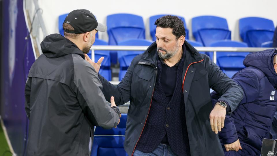 Erol Bulut shakes hands with John Eustace