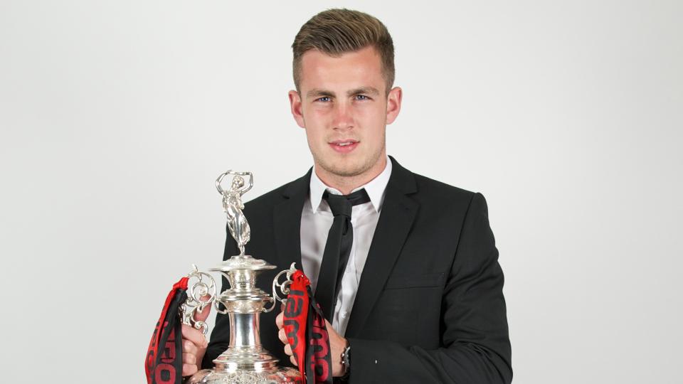 Ralls holds the Championship trophy...