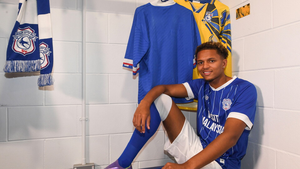 Omari Kellyman surrounded by City memorabilia.