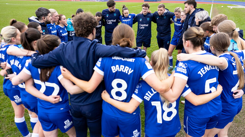 Cardiff City FC Women get together at the end of the match.