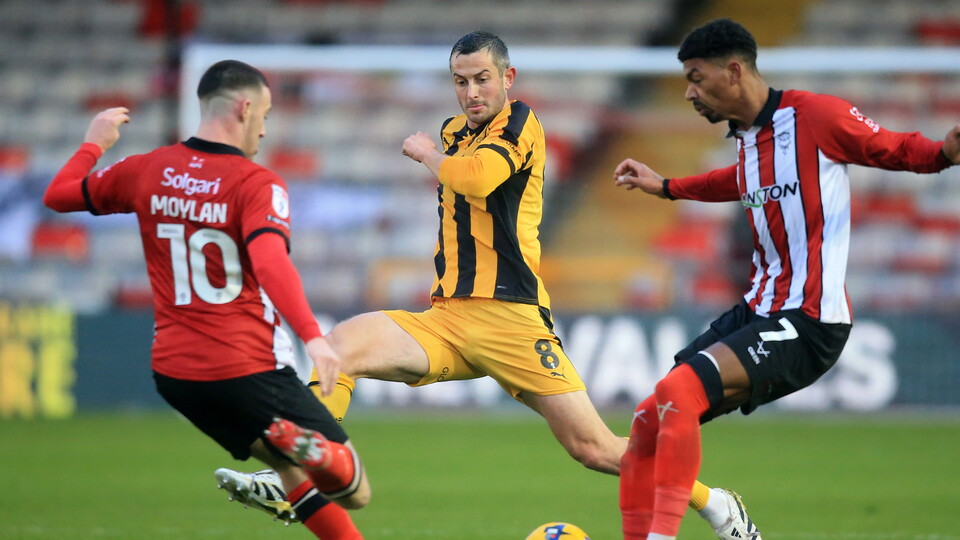 Lincoln City's Jack Moylan and Reeco Hackett in action.