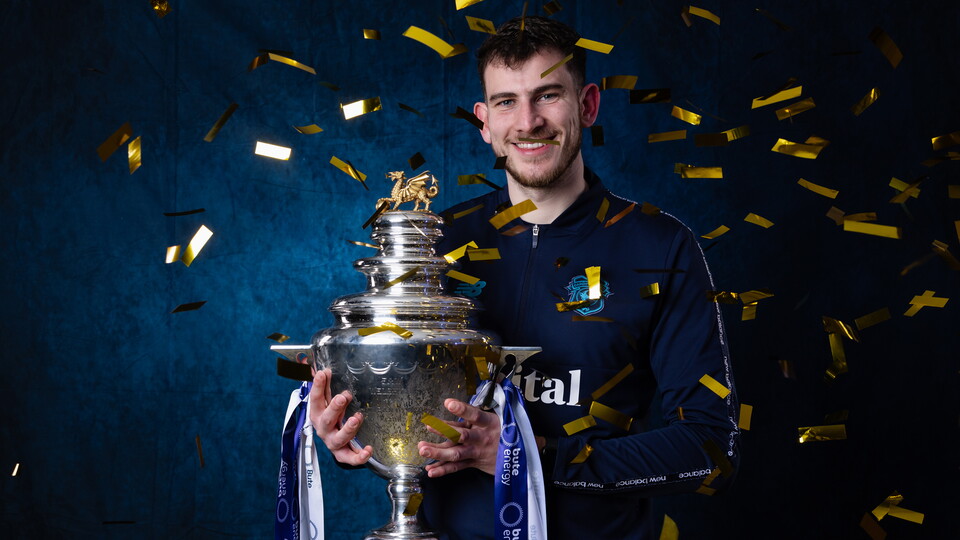 Noah Bushby celebrates with his first trophy in charge of Cardiff City FC Women.