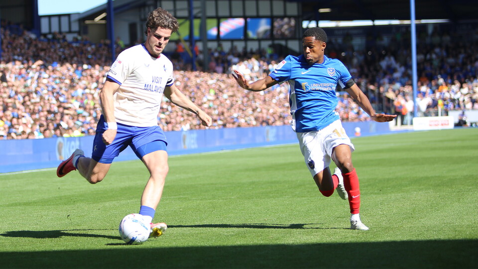 Ollie Tanner crosses the ball at Fratton Park.