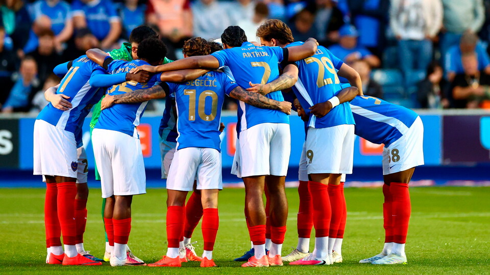 Pompey’s players do a huddle before the match.