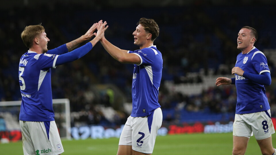 Joel Bagan, Will Fish and Jack Moylan celebrate City's third goal against Watford.