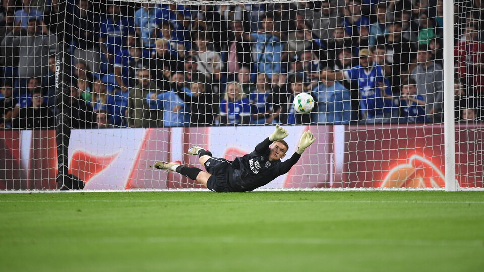 Matt Turner saves a penalty against Cheltenham Town.
