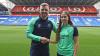 Molly Kehoe shakes hands with head coach Iain Darbyshire after signing for Cardiff City Women
