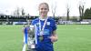 Eliza Collie celebrates with the FAW Women's Cup trophy